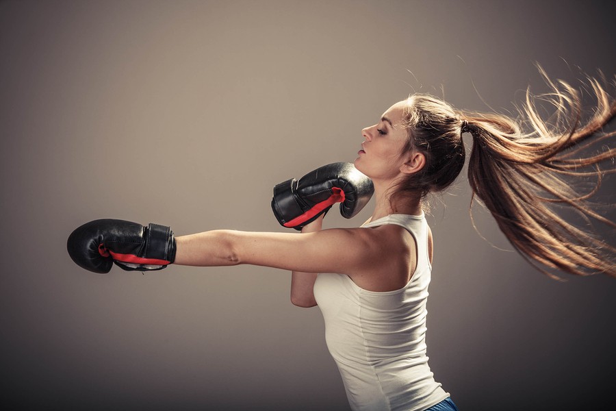 Energetic Young Woman Fight With Boxing Gloves.