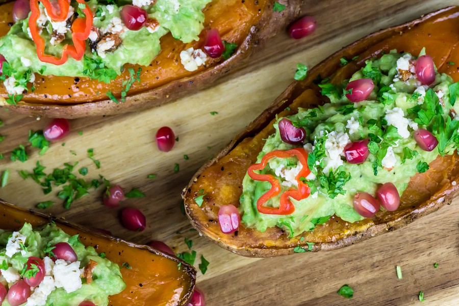 Healthy Food - Baked Sweet Potatoes With Guacamole, Pomegranate - Closeup