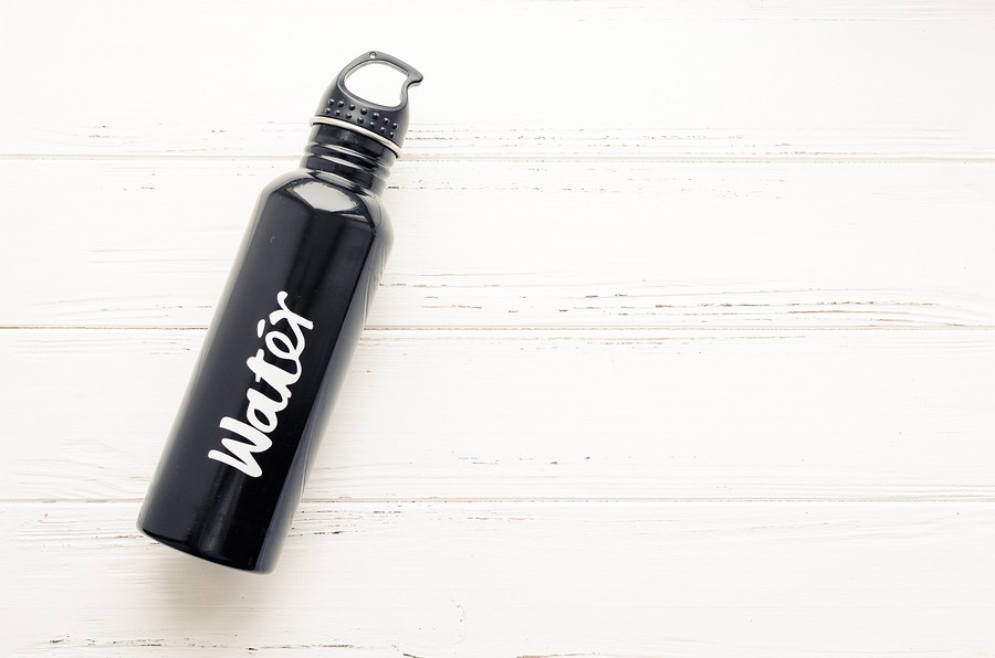 Black Aluminum Reusable Water Bottle On White Shabby Chic Wooden Background With Place For Text. Dri