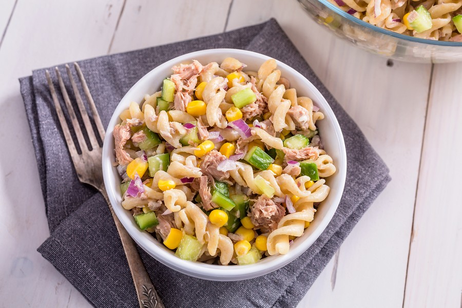 Two Bowls of Freshly-Cooked Pasta Salad with Tuna, Cucumber, Sweetcorn on a White Wooden Table